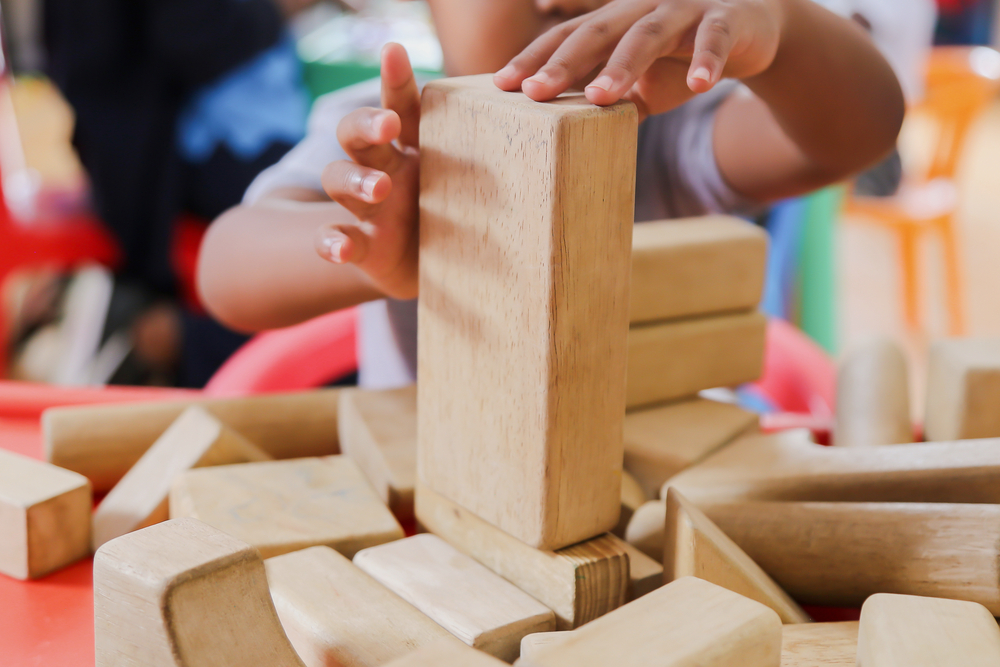 Child building with wood unit blocks