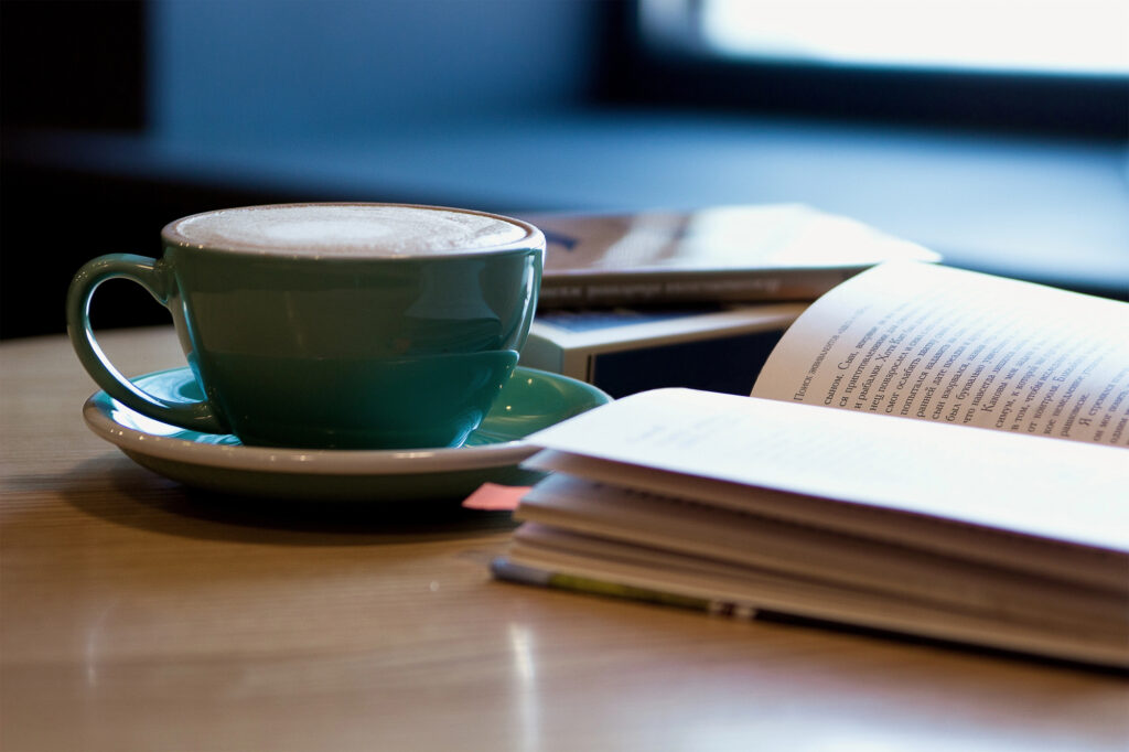 book on a table with coffee
